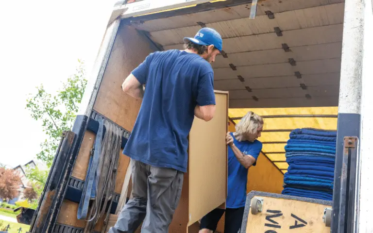 Movers moving a painting into a truck