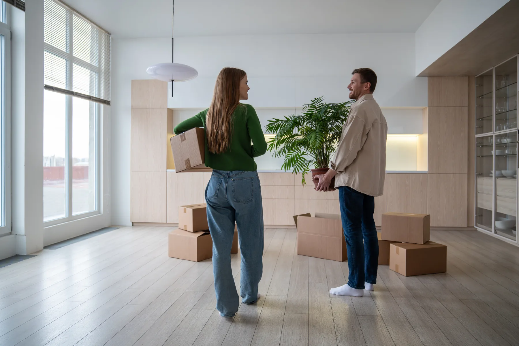 Couple unpacking boxes in new apartment